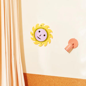 AREAWARE Dusen Dusen Everybody Clock Yellow Sun-shaped clock with a smiley face