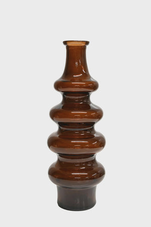 BROSTE Minerva Tall Bottle 40cm - Dark Earth A glossy amber-brown glass vase with a tiered, stacked bulbous design and a flared base