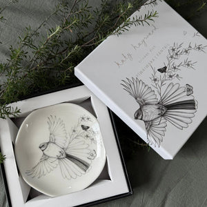 KATY HAYWARD Trinket Dish - Come Fly With Me - Piwaiwaka/Fantail Round ceramic plate with a black and white illustration of a bird and flowers