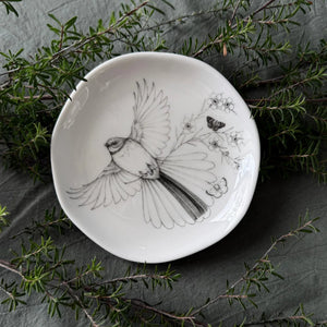KATY HAYWARD Trinket Dish - Come Fly With Me - Piwaiwaka/Fantail Round ceramic plate with a black and white illustration of a bird and flowers