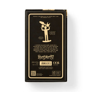 Brass Monkey One Trip Nick Wooden Balance Game Wooden balance game packaging with illustration of a person holding boxes