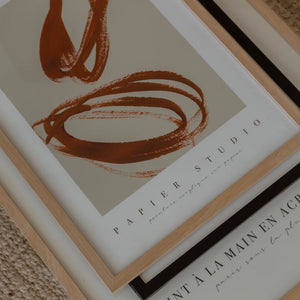 PAPIER HQ ENCLOSED PRINT RUST Abstract art print with brown brush strokes on a beige background, featuring 'Papier Studio' branding.
