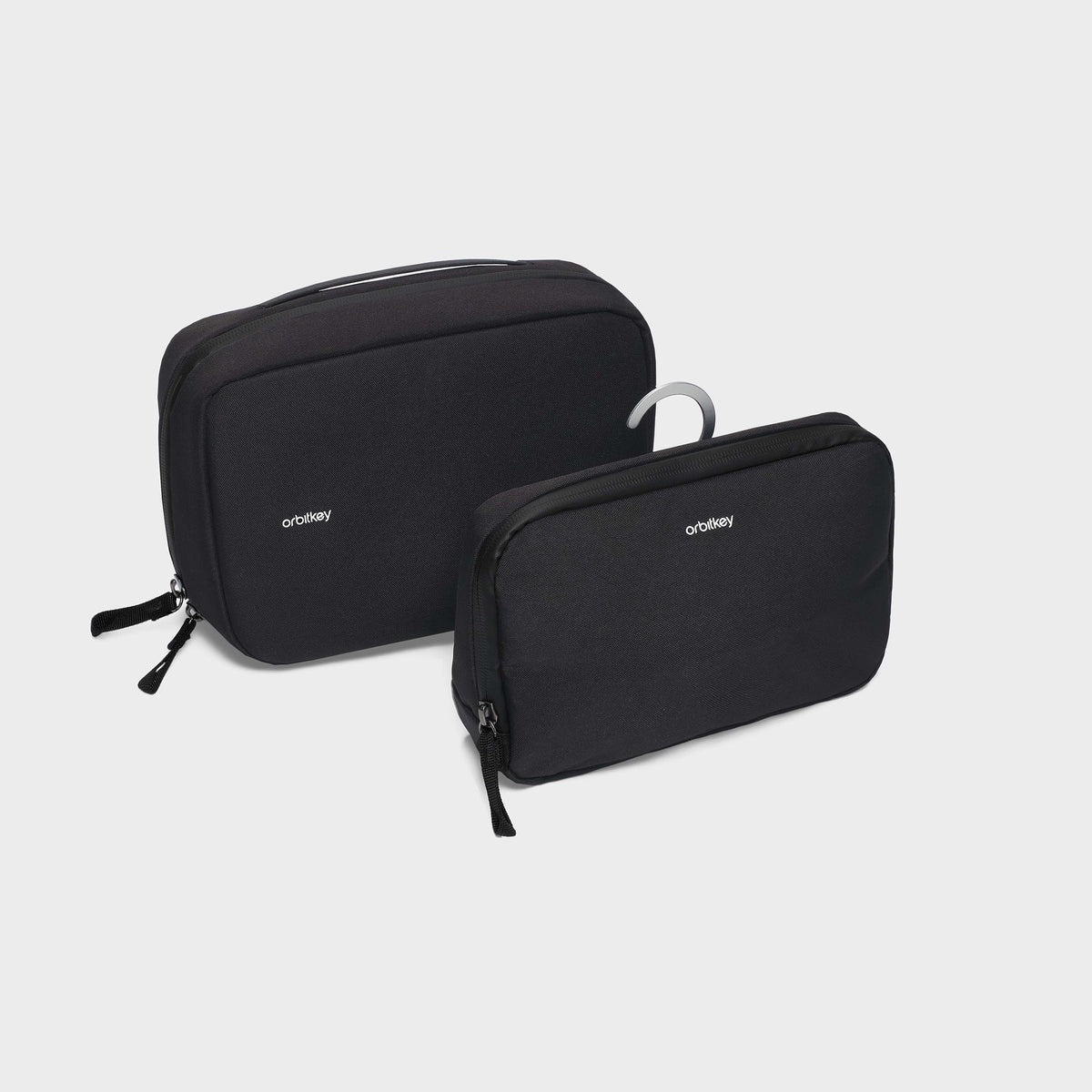 Orbitkey 2-in-1 Toiletry Pouch - Black Two black travel bags with a hook