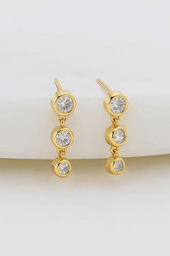 ZAFINO The Abby Earring features a cascading trio of bezel-set crystals that shimmer with every move. Crafted in polished gold, this elegant drop design offers a little extra drama while remaining timeless and versatile. Wear them solo for statement sparkle or pair back with our Amy Stud for a perfectly coordinated look.
Metal: 18K Gold Plated on Brass

Dimensions: 3mm (W) x 13mm (L)

Water Resistant: Splash proof, not recommended to be worn in the ocean or pool