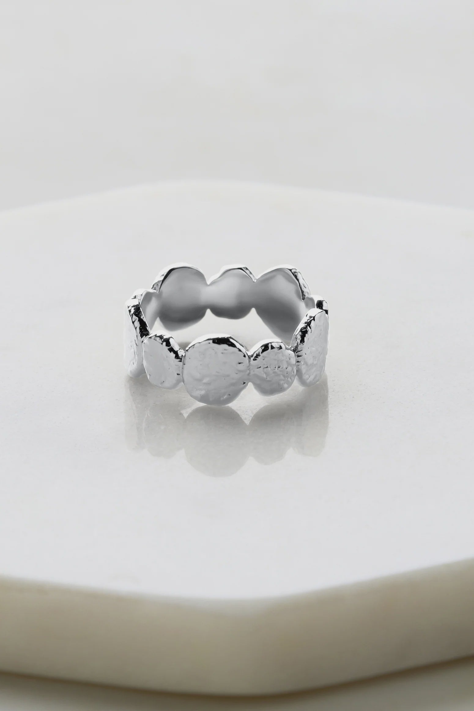 A stunning handcrafted piece from our Artisan Range. Featuring a unique hammered texture and luxurious Silver Rhodium 2-micron plating, this ring is a true testament to refined craftsmanship and timeless elegance. Whether worn solo or stacked, the Chloe Ring adds distinctive sophistication and artistry to any look, making it the perfect statement piece. 

Metal: Silver Rhodium Plated on Brass

Handmade - not recommended to be worn in water