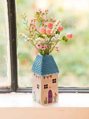 Natural Life Cottage Bud Vase - Teal Cottage Decorative vase shaped like a house with flowers on a windowsill