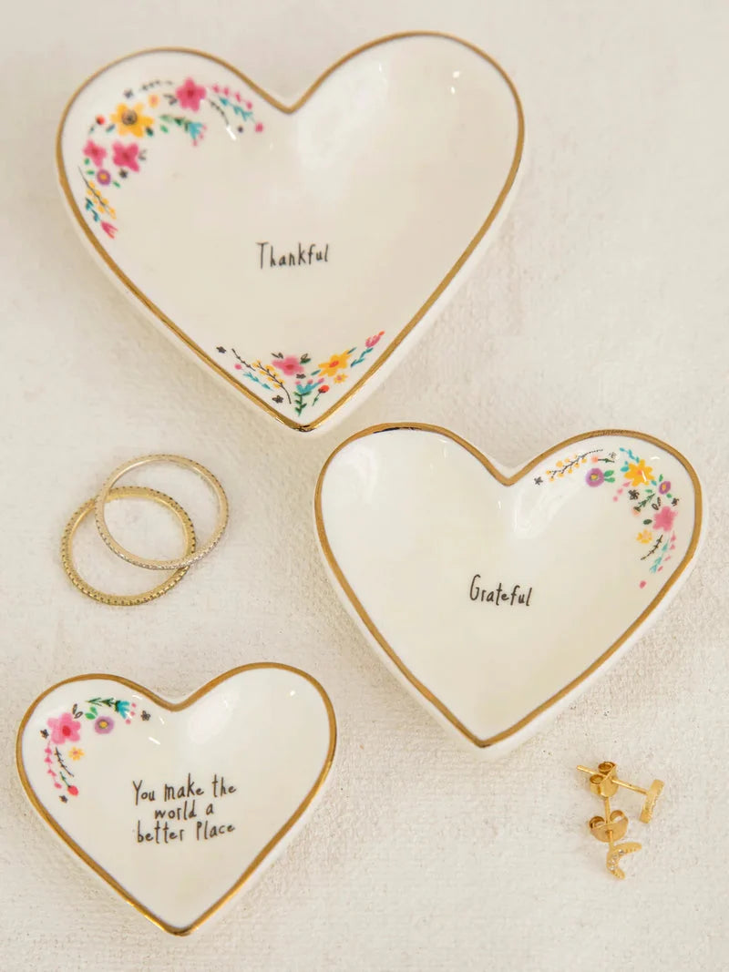 Natural Life Nesting Heart Dishes set of 3 Three small heart-shaped ceramic dishes with gold trim and floral details