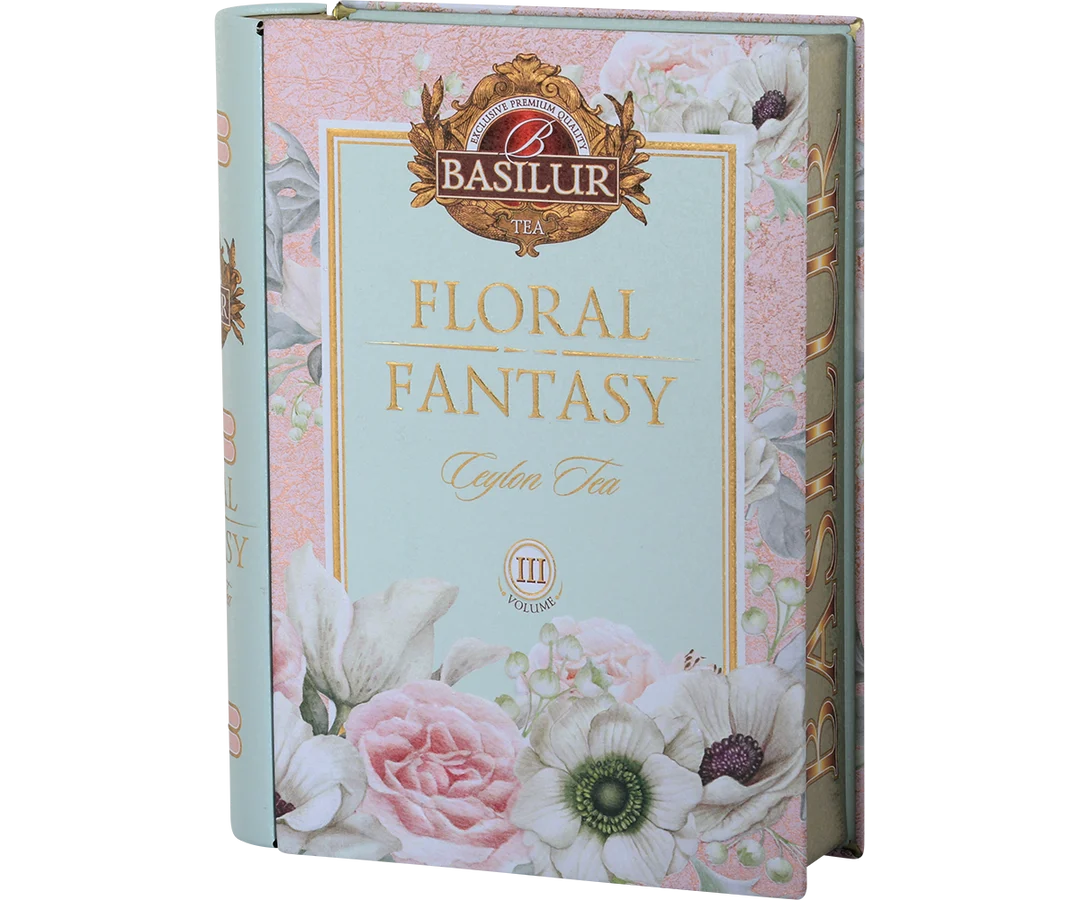 Basilur Tea 'Floral Fantasy' Ceylon Tea box packaging, featuring a pastel pink and mint green floral design with illustrations of roses, anemone, and white flowers. Floral Fantasy Volume III Tea Book - 100g Loose Leaf Green Tea
