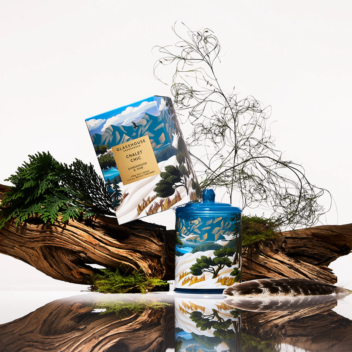 Glasshouse Fragrances Chalet Chic candle and packaging with mountain and nature design. AMBERWOOD OUD 380g Triple Scented Soy Candle Limited Edition