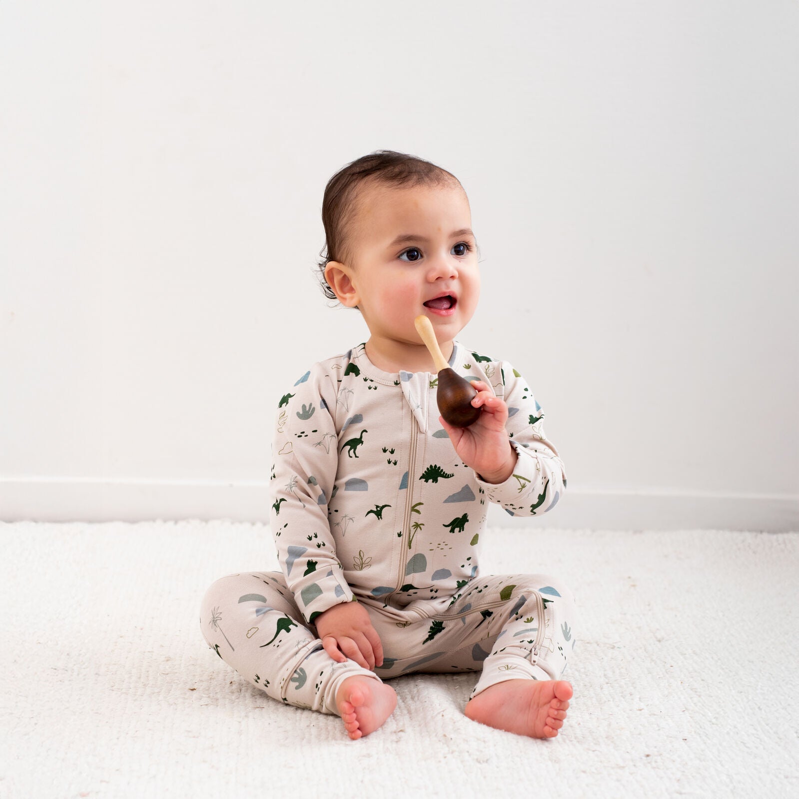 Burrow & Be Jurassic Roam Long Sleeve Zip Suit Baby onesie with dinosaur pattern