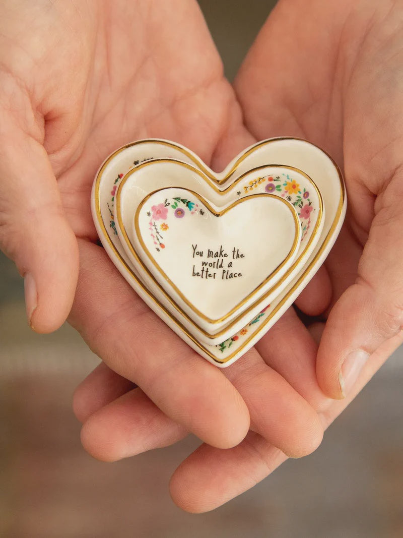 Natural Life Nesting Heart Dishes set of 3 Three small heart-shaped ceramic dishes with gold trim and floral details