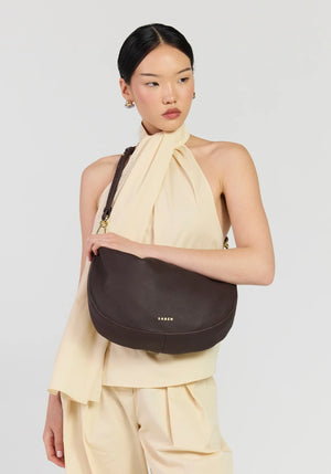 SABEN SS26 Noa Shoulder Bag - Cacao Luxe dark brown crescent-shaped leather shoulder bag