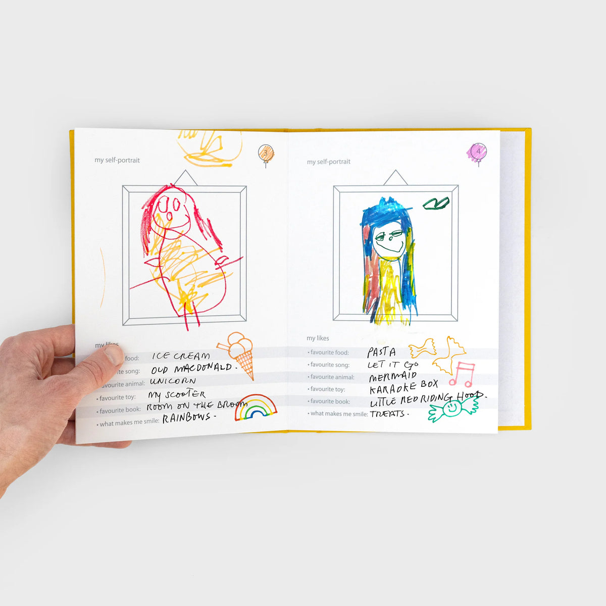 Suck UK My Height Chart A children's collapsible height chart book shown standing upright on a light gray background. The cover is white with bold yellow text reading 'MY HEIGHT CHART,' plus illustrations of folded pages and a young girl in a light blue dress standing beside the chart area.