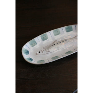 Sushi Plate Fish An oval ceramic serving platter featuring a molded fish in the center and a border of textured sage green squares with blue accents