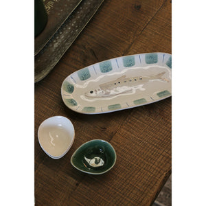 Sushi Plate Fish An oval ceramic serving platter featuring a molded fish in the center and a border of textured sage green squares with blue accents