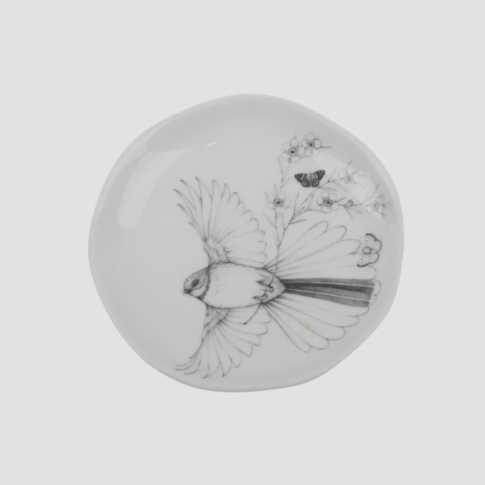 KATY HAYWARD Trinket Dish - Come Fly With Me - Piwaiwaka/Fantail Round ceramic plate with a black and white illustration of a bird and flowers
