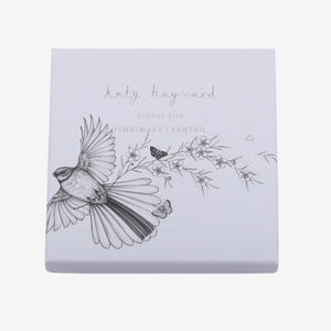 KATY HAYWARD Trinket Dish - Come Fly With Me - Piwaiwaka/Fantail Round ceramic plate with a black and white illustration of a bird and flowers