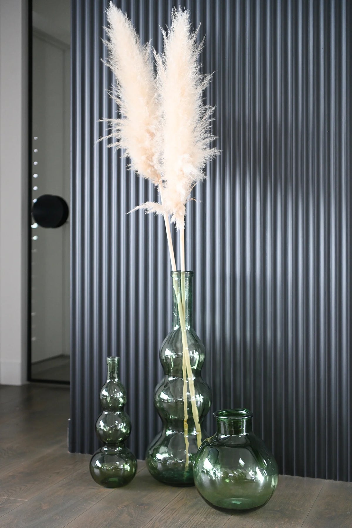 Broste Eteria Bottle 75cm - Spring Green A green glass vase with a distinctive three-bulb, gourd-like silhouette and a narrow neck