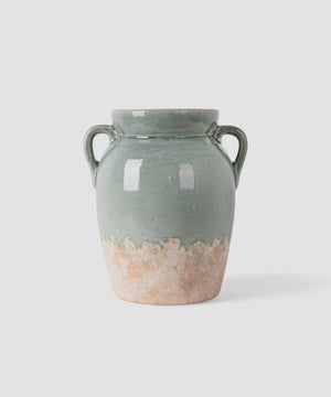 French Country Collections Varese Vessel Tall Pale Blue A handmade ceramic vase with two side handles, featuring a sage green glazed upper body and a rustic, unglazed terracotta-colored base