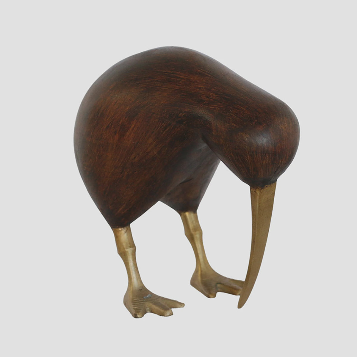 Wooden Brown Kiwi with Brass Legs and Beak A kiwi bird sculpture made of dark brown wood with metallic gold-colored legs and beak