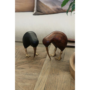 Wooden Brown Kiwi with Brass Legs and Beak A kiwi bird sculpture made of dark brown wood with metallic gold-colored legs and beak