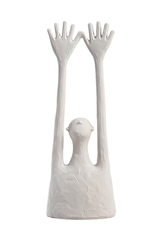 Yay Sculpture White ceramic sculpture of a bird perched between two human-like hands