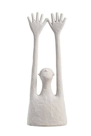 Yay Sculpture White ceramic sculpture of a bird perched between two human-like hands