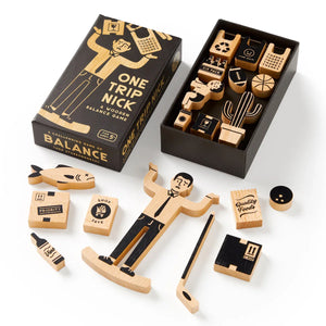 Brass Monkey One Trip Nick Wooden Balance Game Wooden balance game packaging with illustration of a person holding boxes