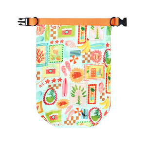 Dock & Bay Dry Bag 5L - Wish You Were Here A small dry bag with a colorful patchwork print featuring beach and tropical motifs, an orange webbing strap, and a black quick-release buckle